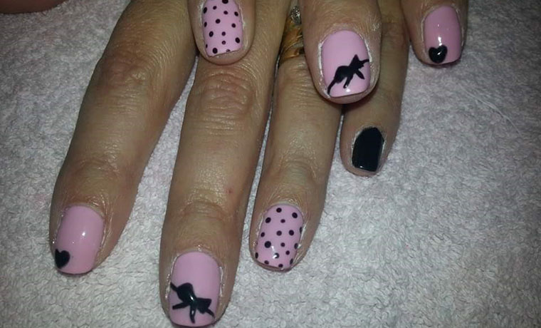 Freehand polka dot and bow nail art